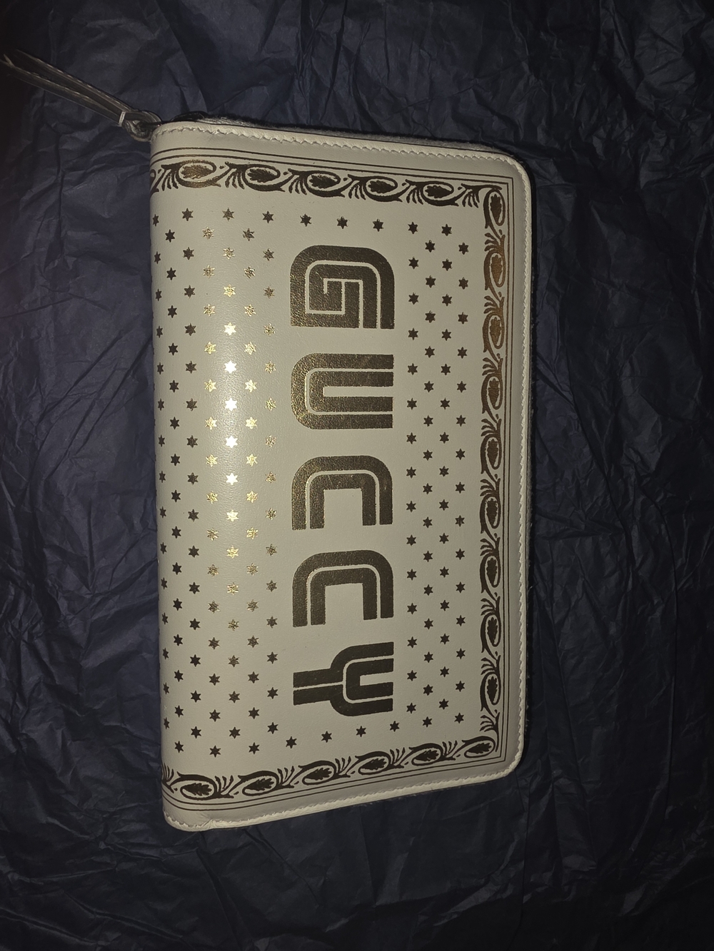 Gucci Guccy SEGA star zip-around leather wallet in white and gold.